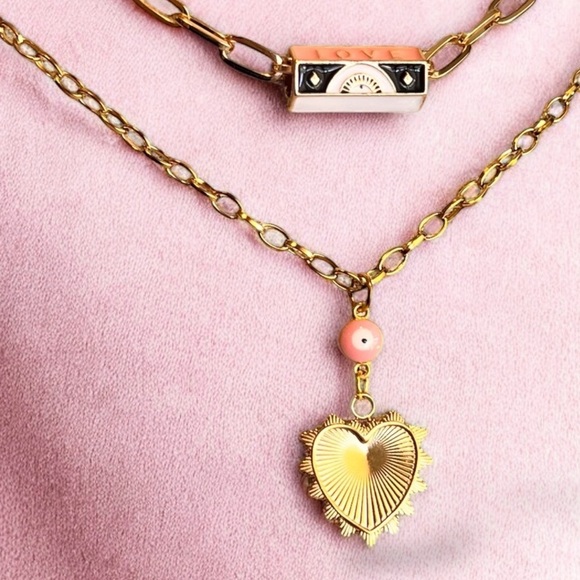 Gold toned chains with black, white, gold, and pastel pink enamel charms. - Picture 7 of 17